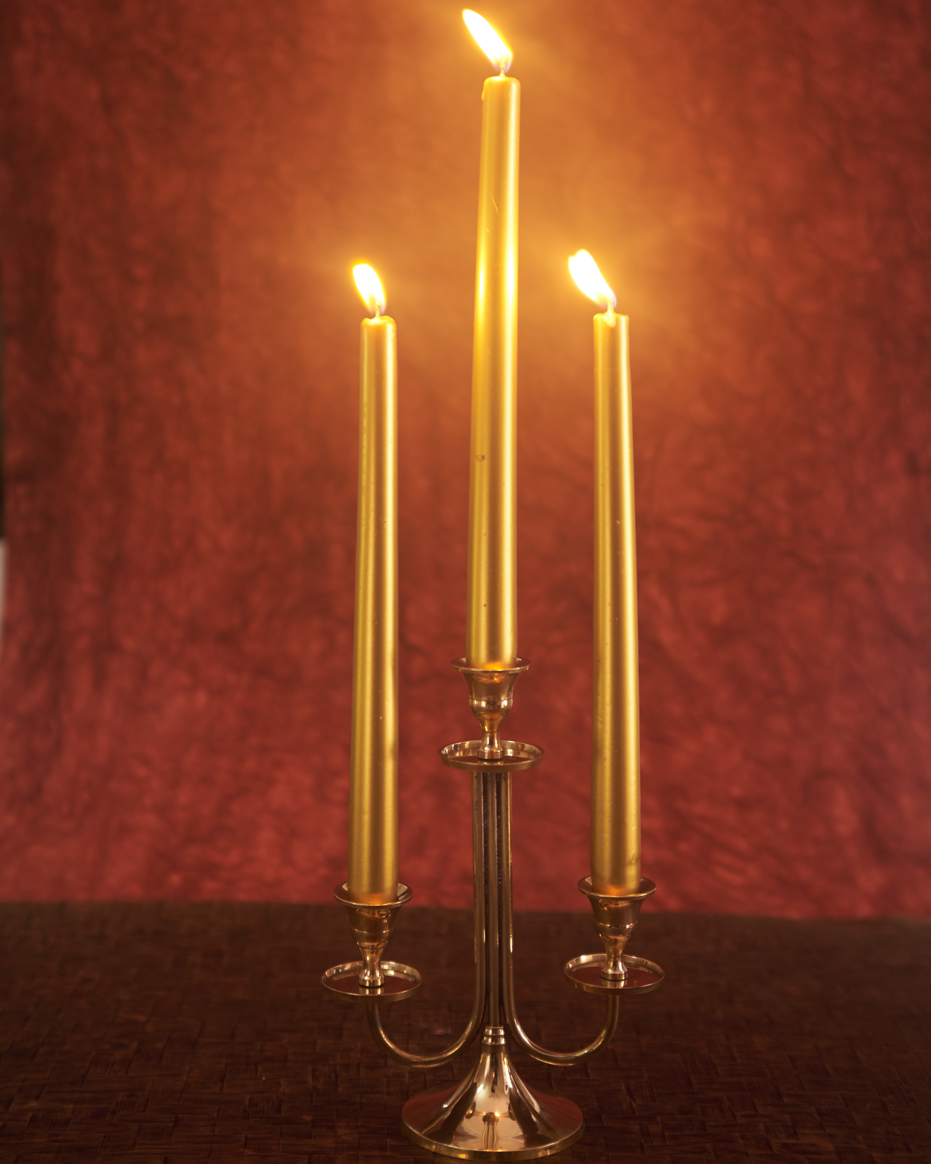 Brass three arm candelabra glowing candlelight classic vintage style living room decor