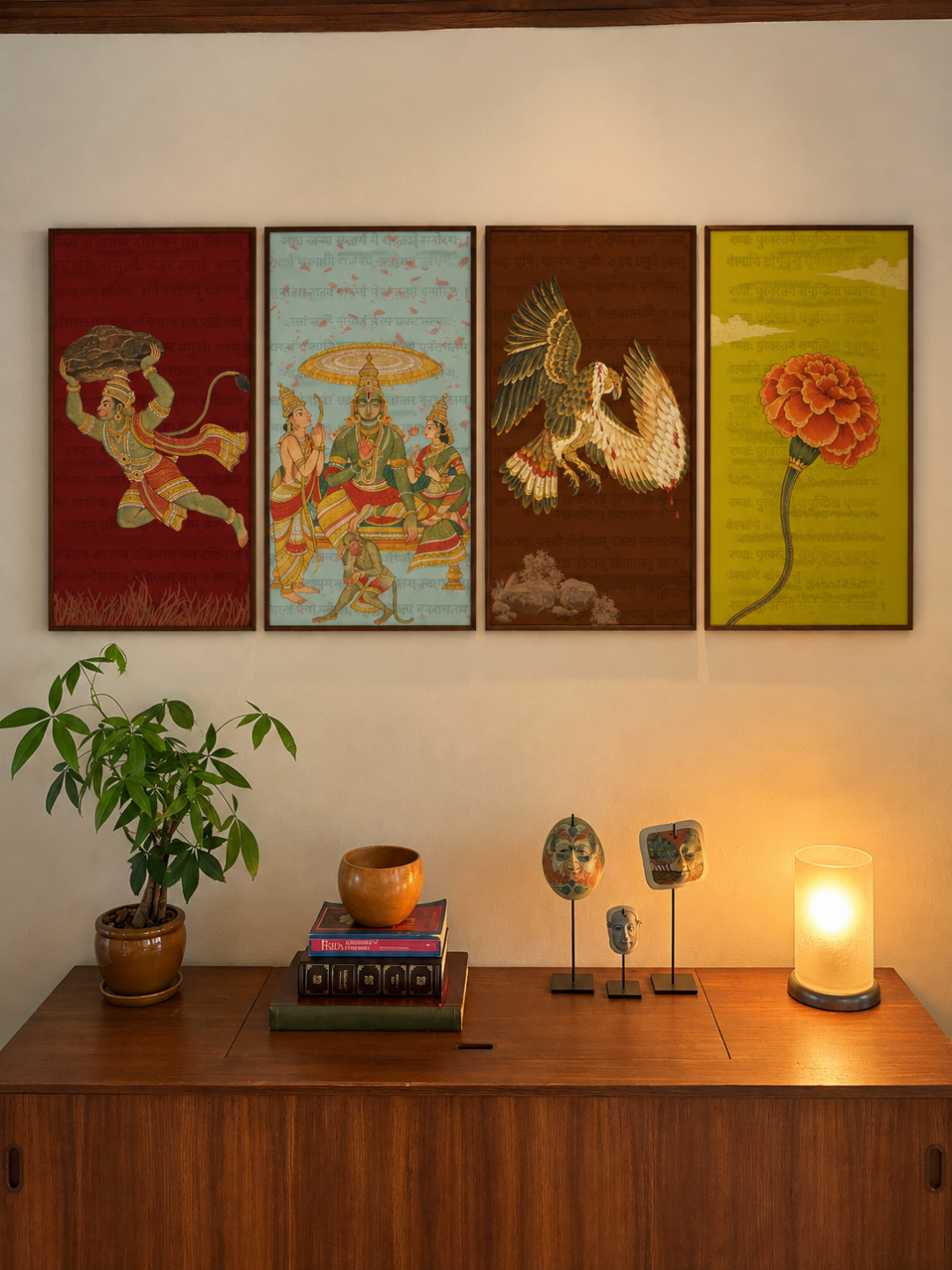 Four Ramayana panel art prints of a vanara carrying a rock, Rama enthroned, Jatayu and a marigold framed above a sideboard