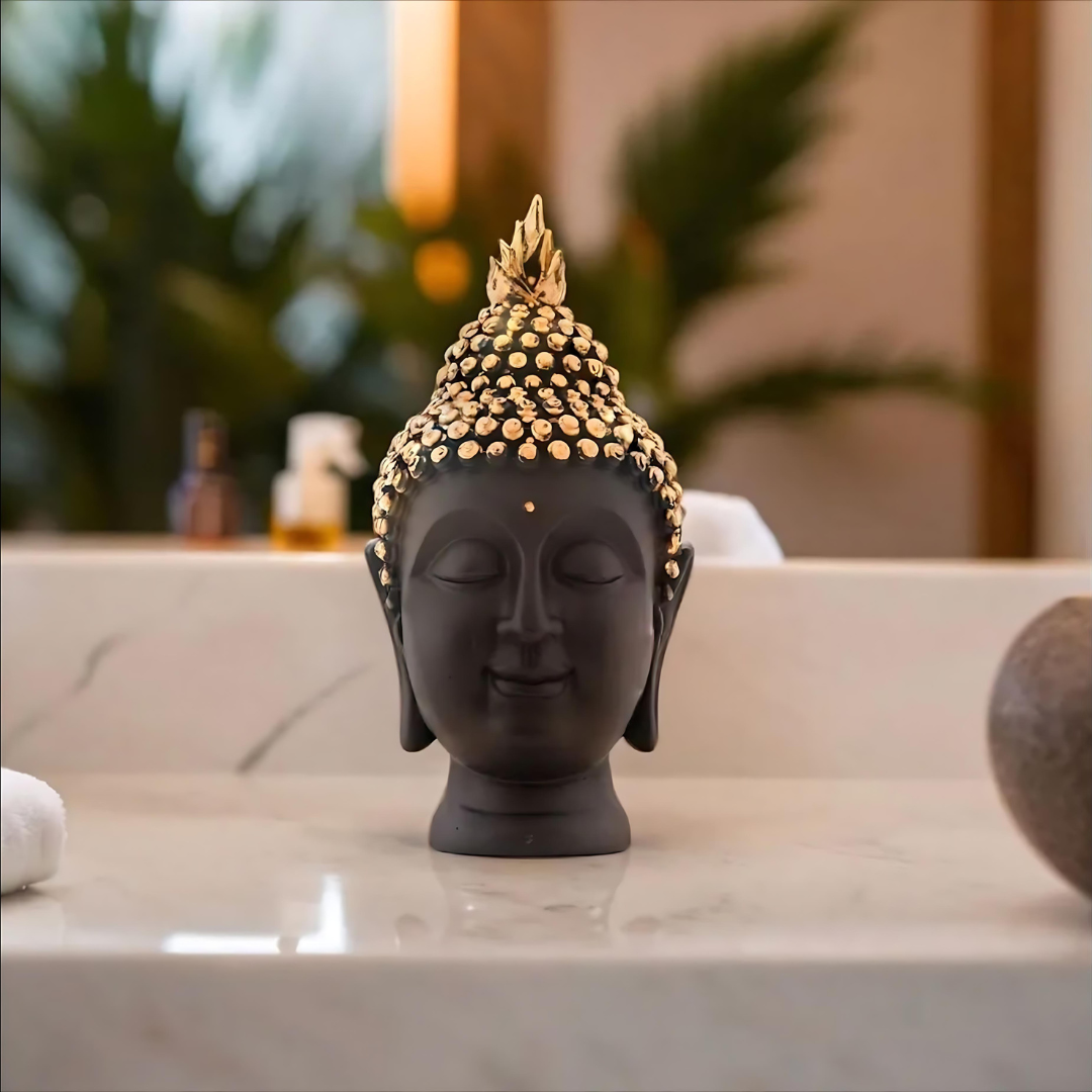 Black resin Buddha head with gold accents placed on table – modern spiritual decor for living room