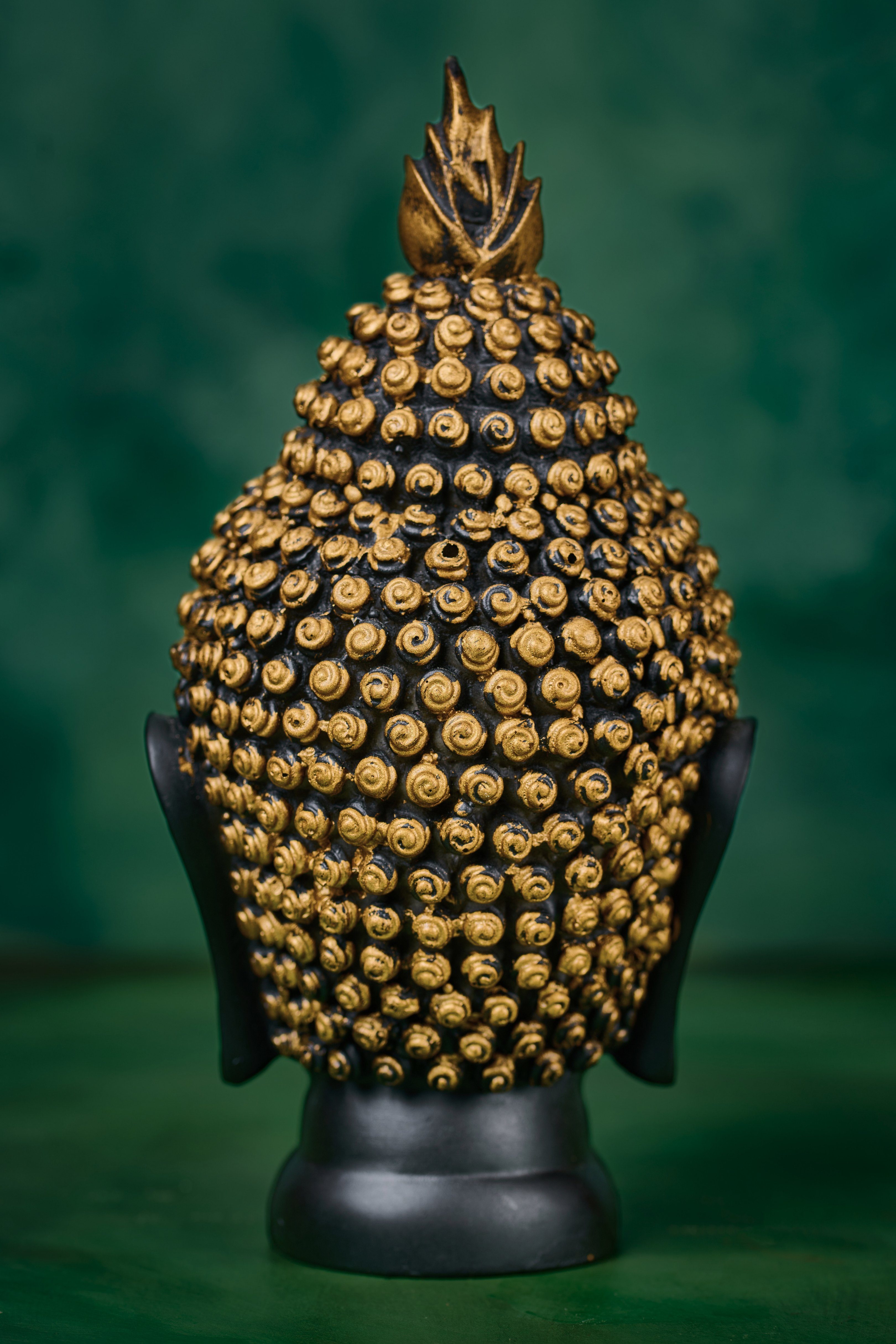 Side view of black Buddha head with gold detailing – handcrafted spiritual statue for home altar