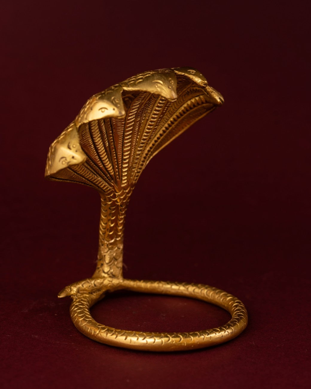 Coiled brass serpent statue naga snake figure Indian symbolism decor for home altar