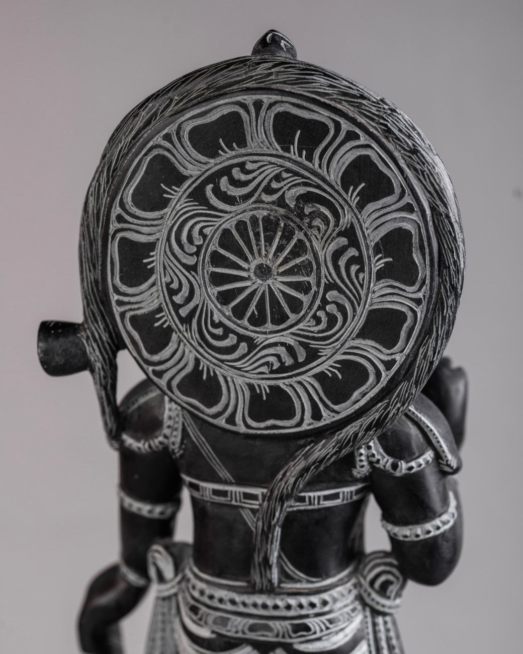 Rear view of black stone Hanuman statue showing sculptural depth and polished finish.