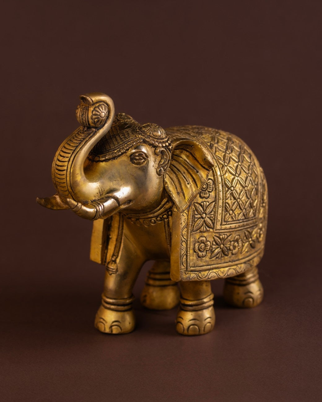 Engraved brass elephant statue with traditional patterns