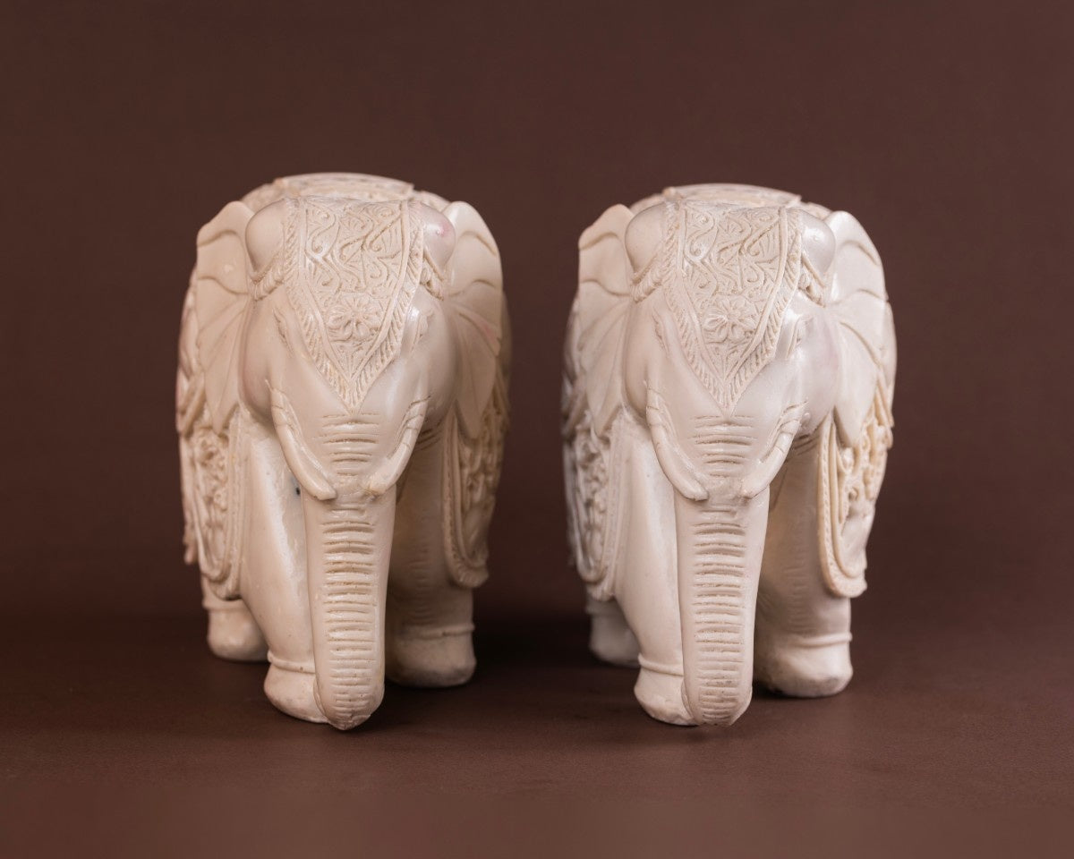 Indian décor white elephant sculpture set carved with intricate patterns and artisanal texture.