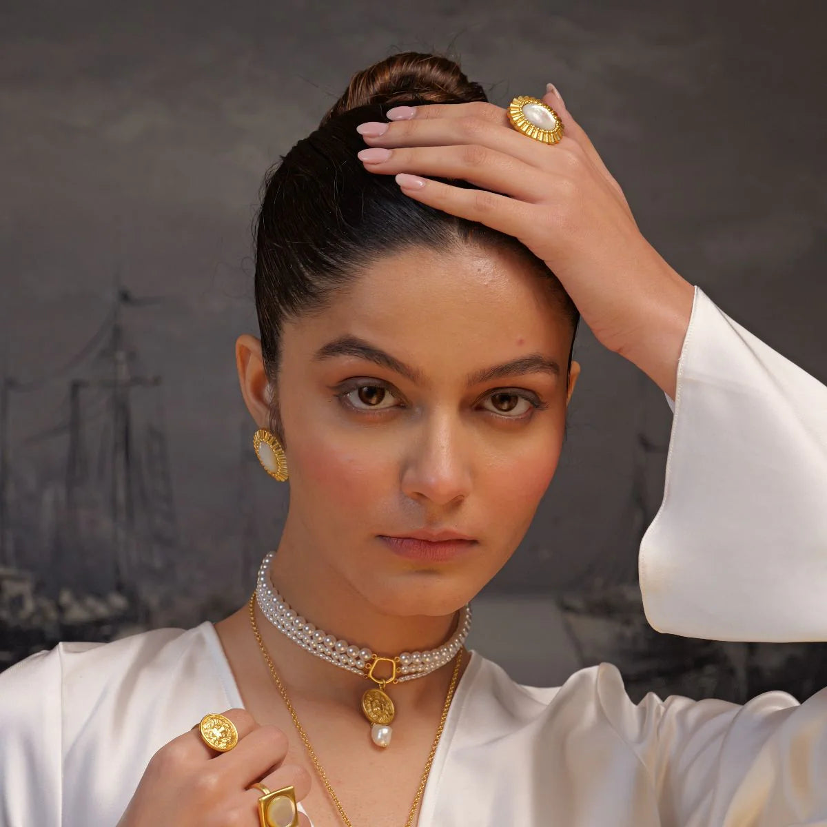 gold pearl choker with coin pendant styled on woman in elegant outfit