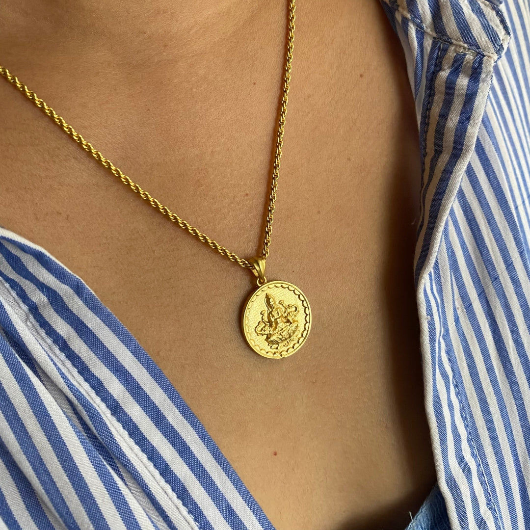 woman wearing gold devi lakshmi coin pendant necklace with twisted chain