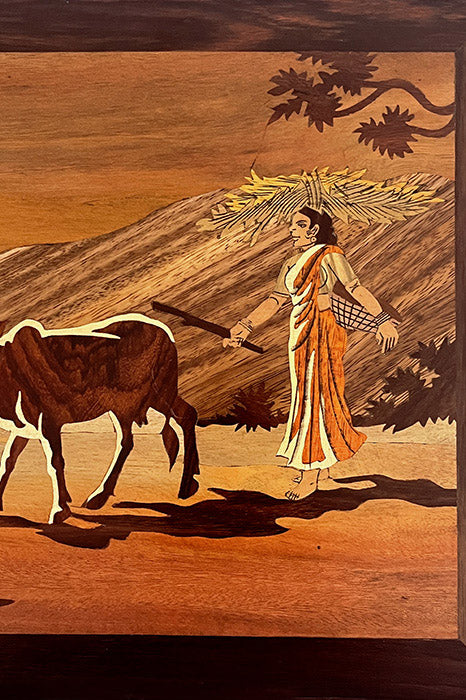 Close-up of Mysore rosewood inlay craftsmanship showing cow grazing motif, natural wood inlay detailing and hand-carved finish