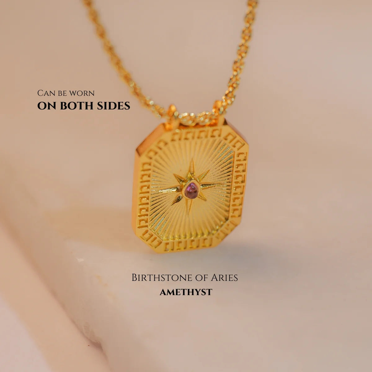 Close-up of gold Aquarius zodiac tablet necklace with blue enamel front and water-bearer motif