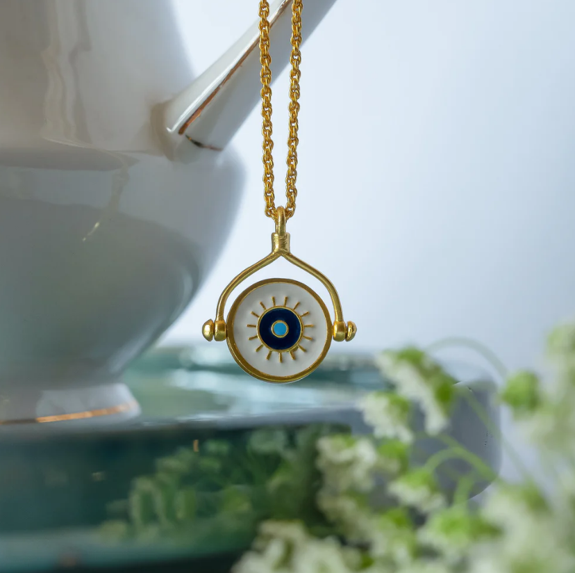 woman wearing gold-plated evil eye hamsa necklace, spiritual everyday protection jewelry