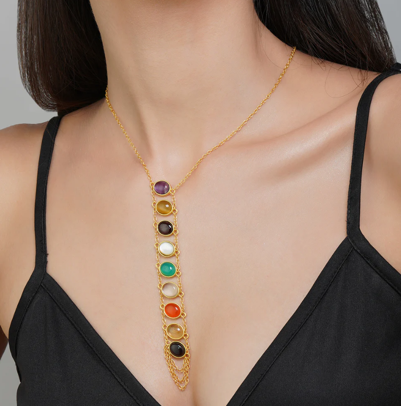 polished gold navratan pendant necklace styled on neckline, modern spiritual jewelry for women, daily wear accessory
