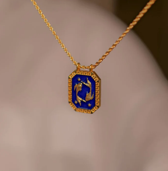 Gold Pisces zodiac tablet necklace with blue enamel front and twin fish motif