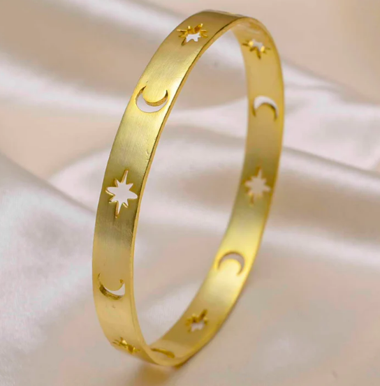 polished gold celestial bangle with star and moon symbols, spiritual everyday bracelet for women