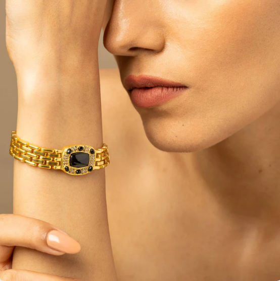 18k gold-finish oval black tourmaline bracelet on wrist, minimalist unisex statement jewelry