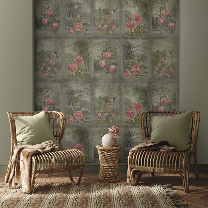 Two wicker chairs with cushions in a room with floral wallpaper.