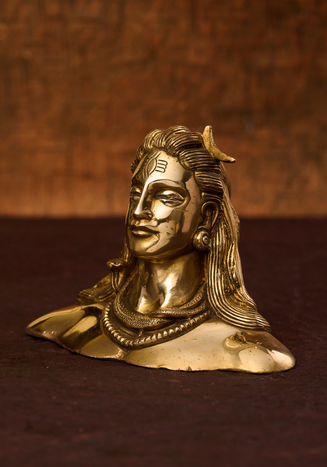 Side view of brass bust of Adiyogi Shiva – Indian brass statue of siva with cobra around his neck