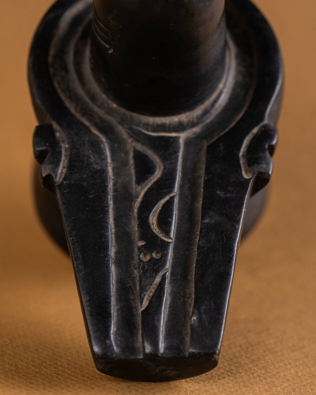 Top view detail of black stone Shivling showing smooth cylindrical form