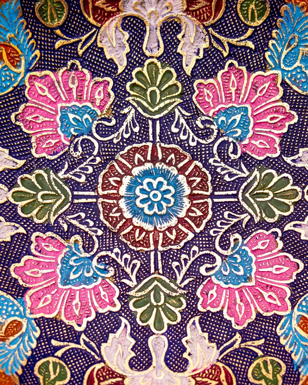 Colorful floral and geometric pattern on brass plate - artisanal Indian craftsmanship decor