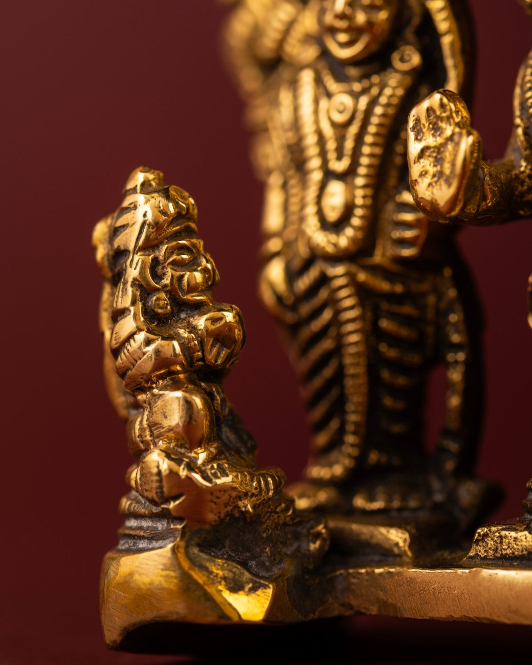 Detailed close-up of brass Ram Darbar statue highlighting Hanuman kneeling at the feet of Rama, Sita, and Lakshmana.