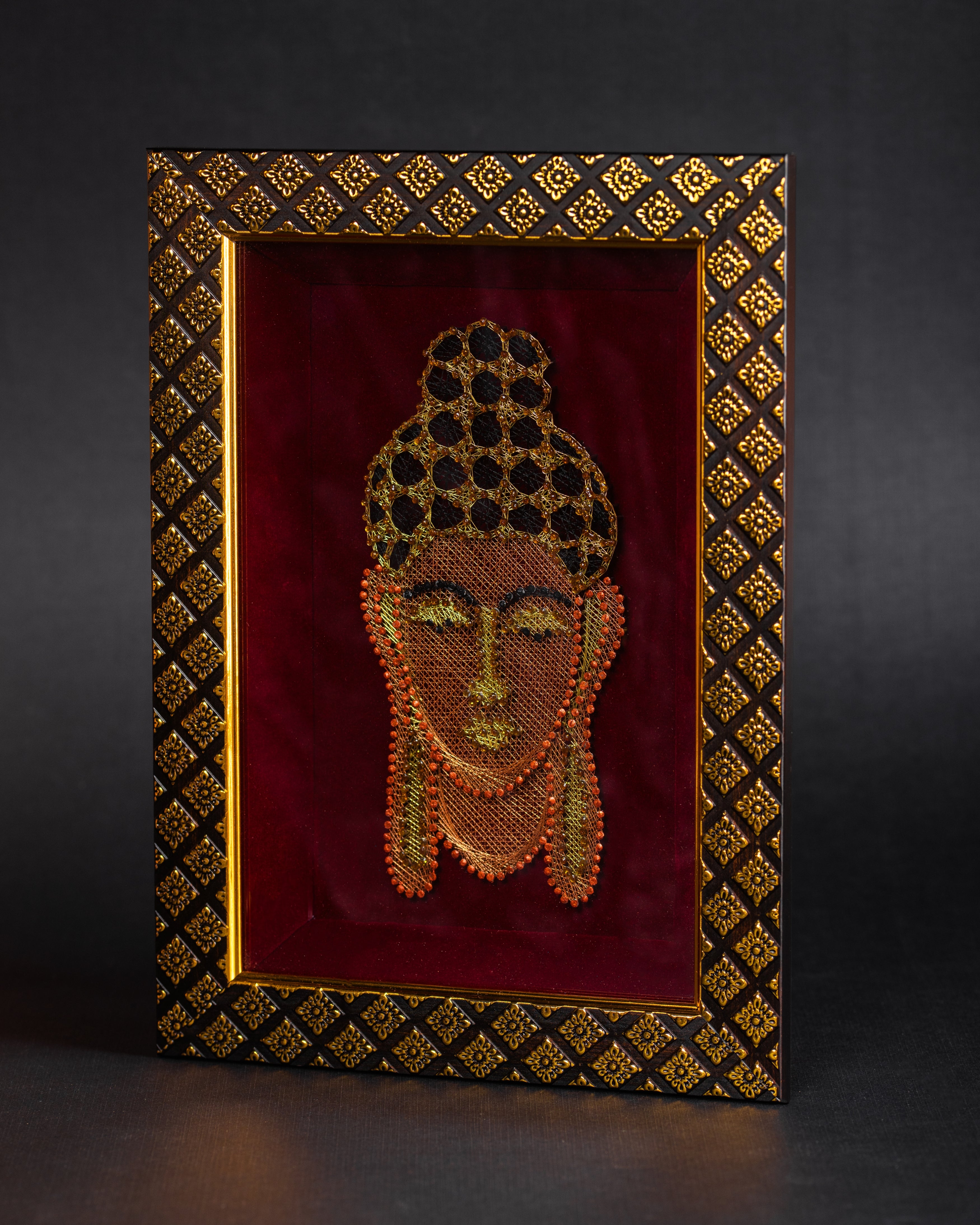 Framed Buddha Zardozi embroidery displayed at an angle highlighting texture