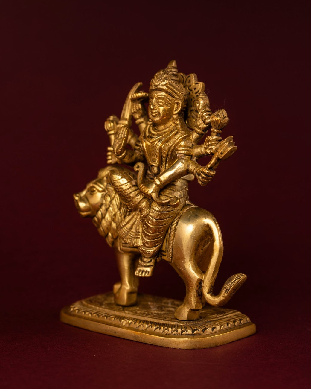 Close-up of Indian brass sculpture of Durga on lion – detailed artisan brass statue