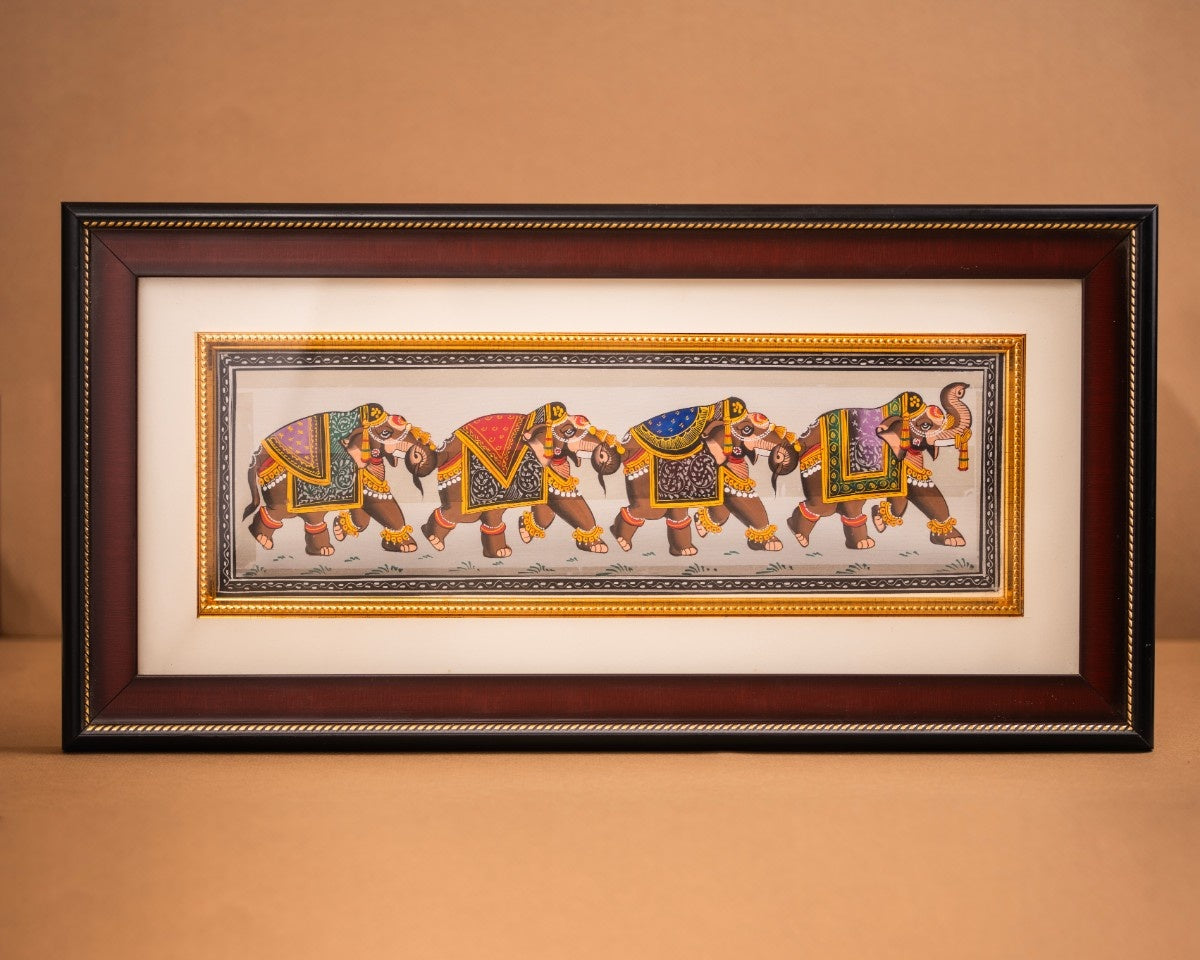 Framed elephant procession painting featuring a vibrant ceremonial march in traditional Indian style