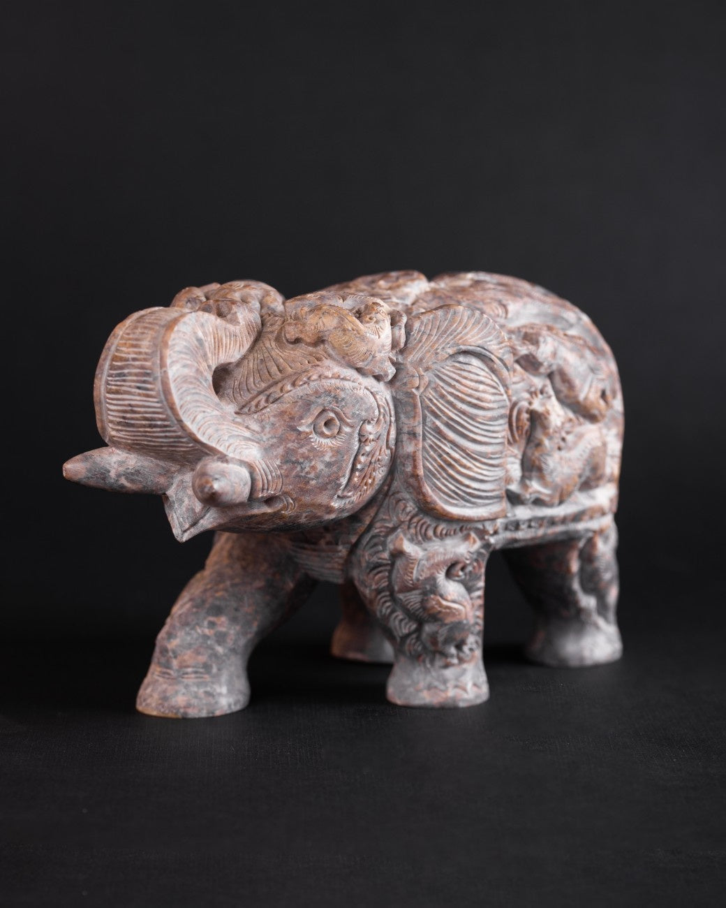 white marble elephant figure with engraving