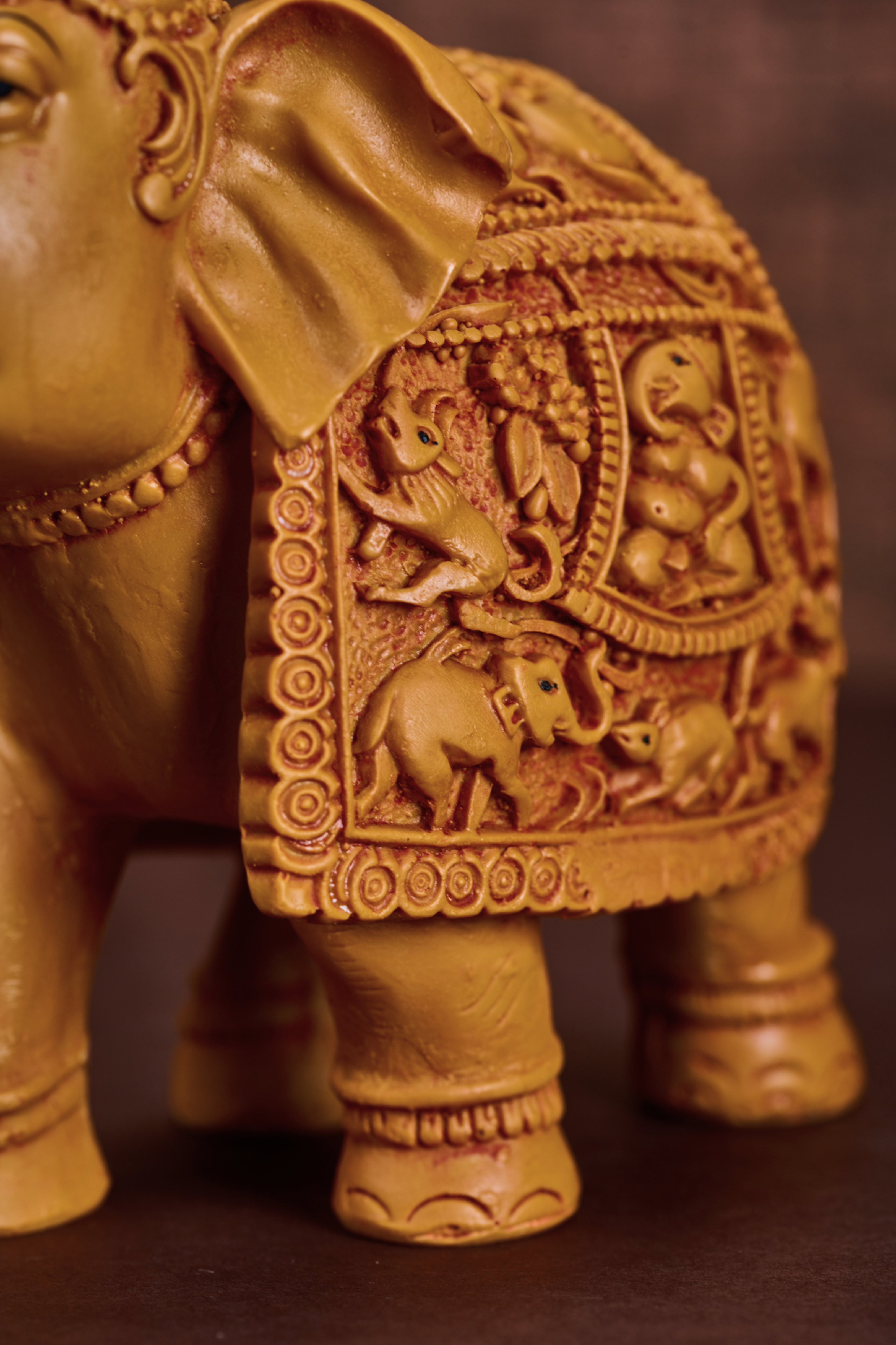 Hand carved wooden elephant sculpture featuring intricate detailing and a majestic, heritage inspired design