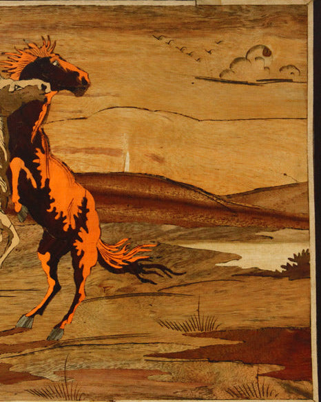 Close-up detail of Mysore rosewood inlay artwork highlighting finely fitted natural wood inlay and craftsmanship in a horse playing scene.