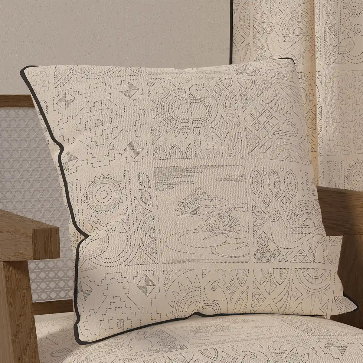 The "Kantha Pipin" cushion cover displayed on a wooden chair, showcasing its elegant, understated style in a home setting.