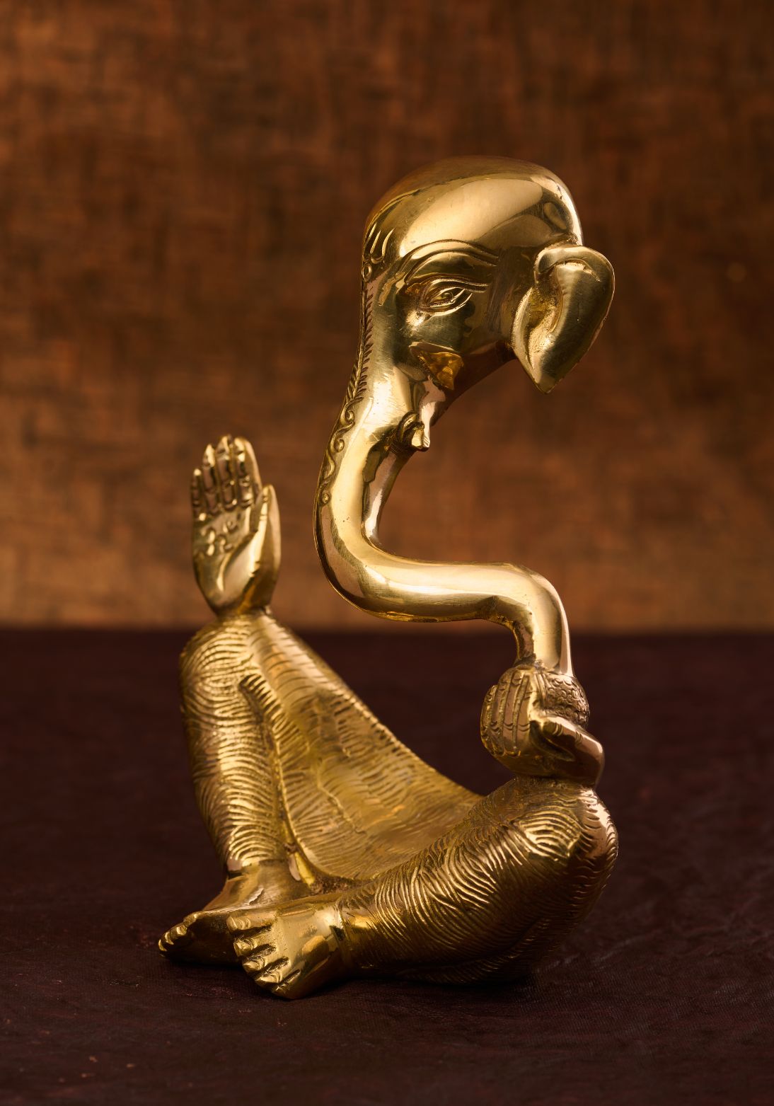 Close‑up of etched details on the cut‑out brass Lord Ganesh statue – artisan brass sculpture.