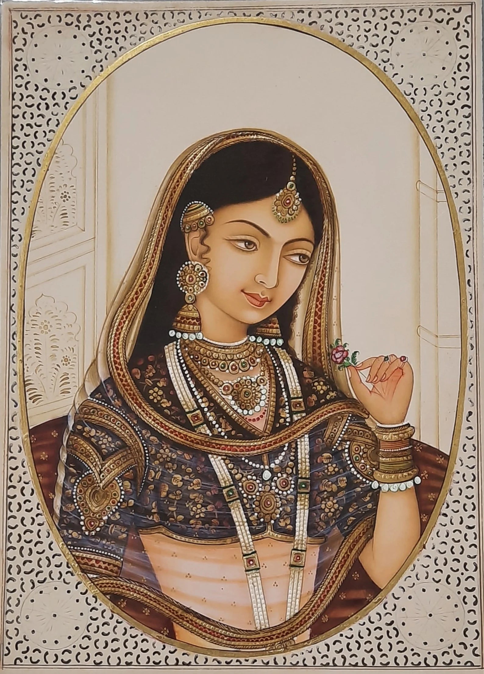 Mughal miniature portrait of a royal woman framed within an oval cartouche
