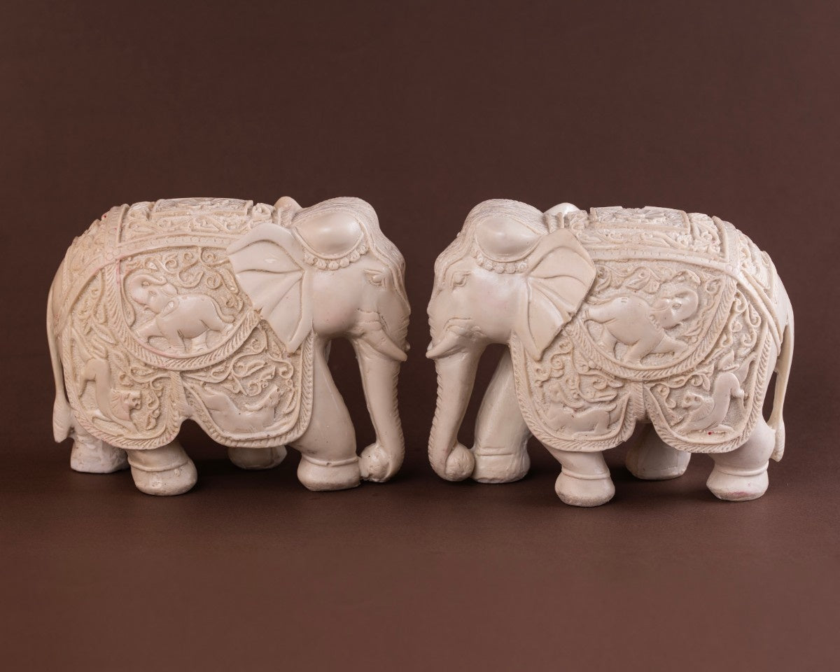 Carved elephant sculpture set white elephant statues with detailed patterns and textured Indian craftsmanship.