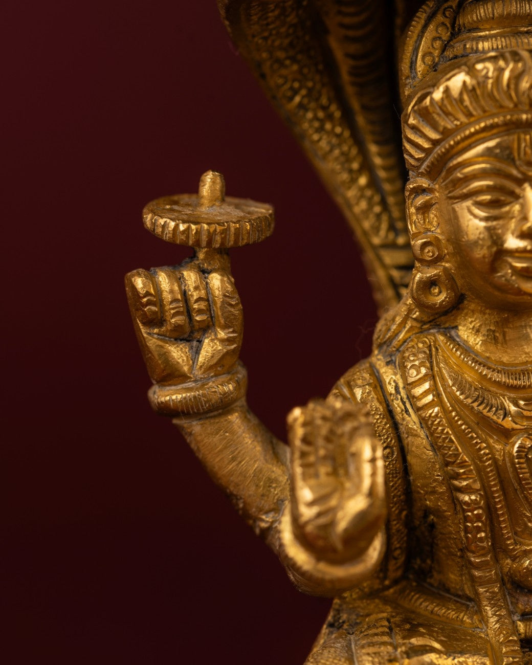 Detail of hand gesture and brass craftsmanship on Shiva Naga sculpture