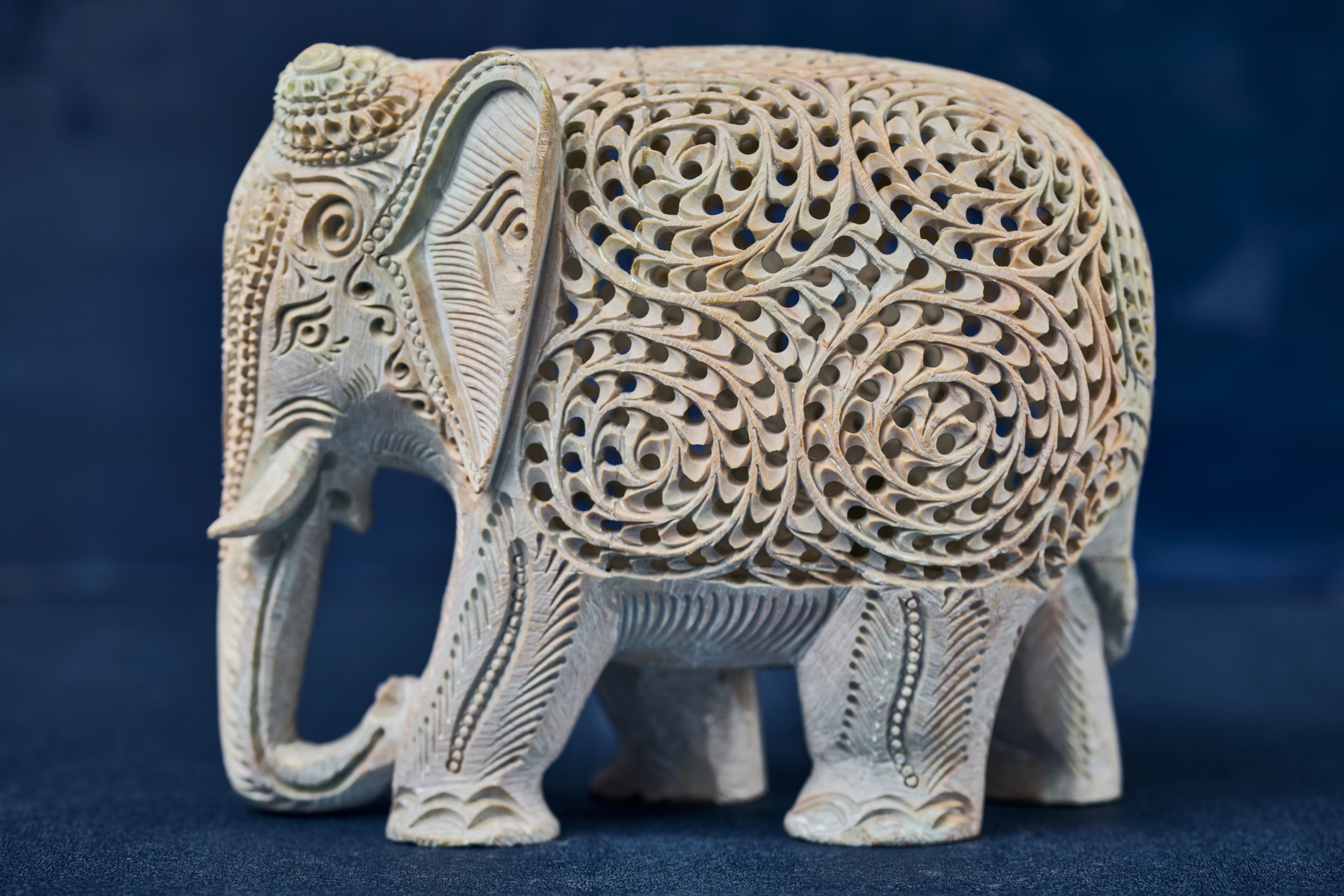 White stone elephant sculpture with detailed carving, designed as a symbolic and timeless home décor accent