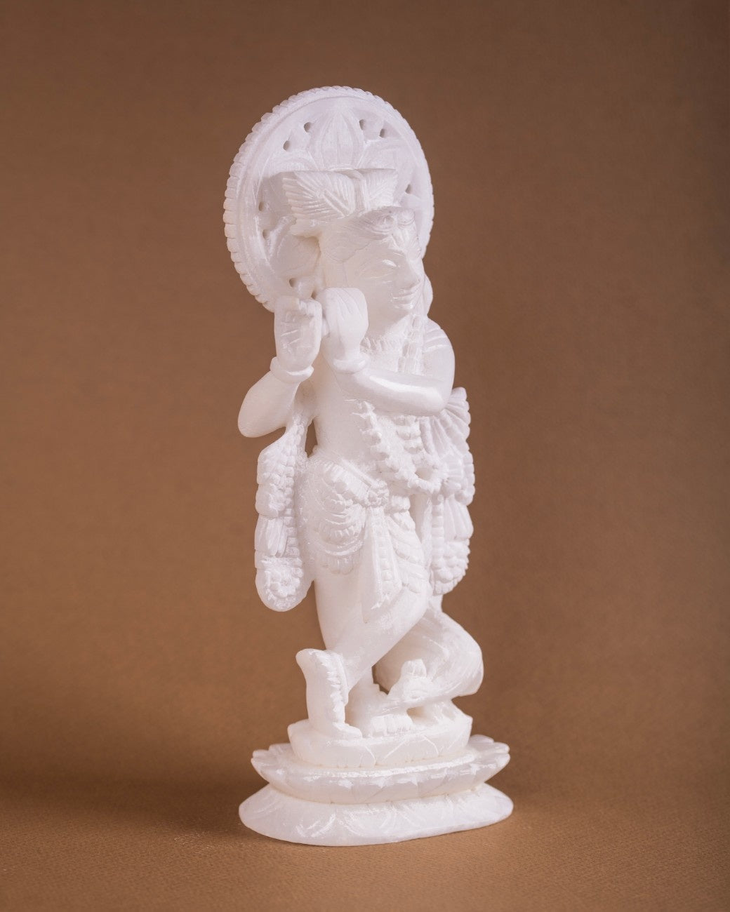 Krishna statue white marble hand-carved idol playing flute traditional Indian sculpture.