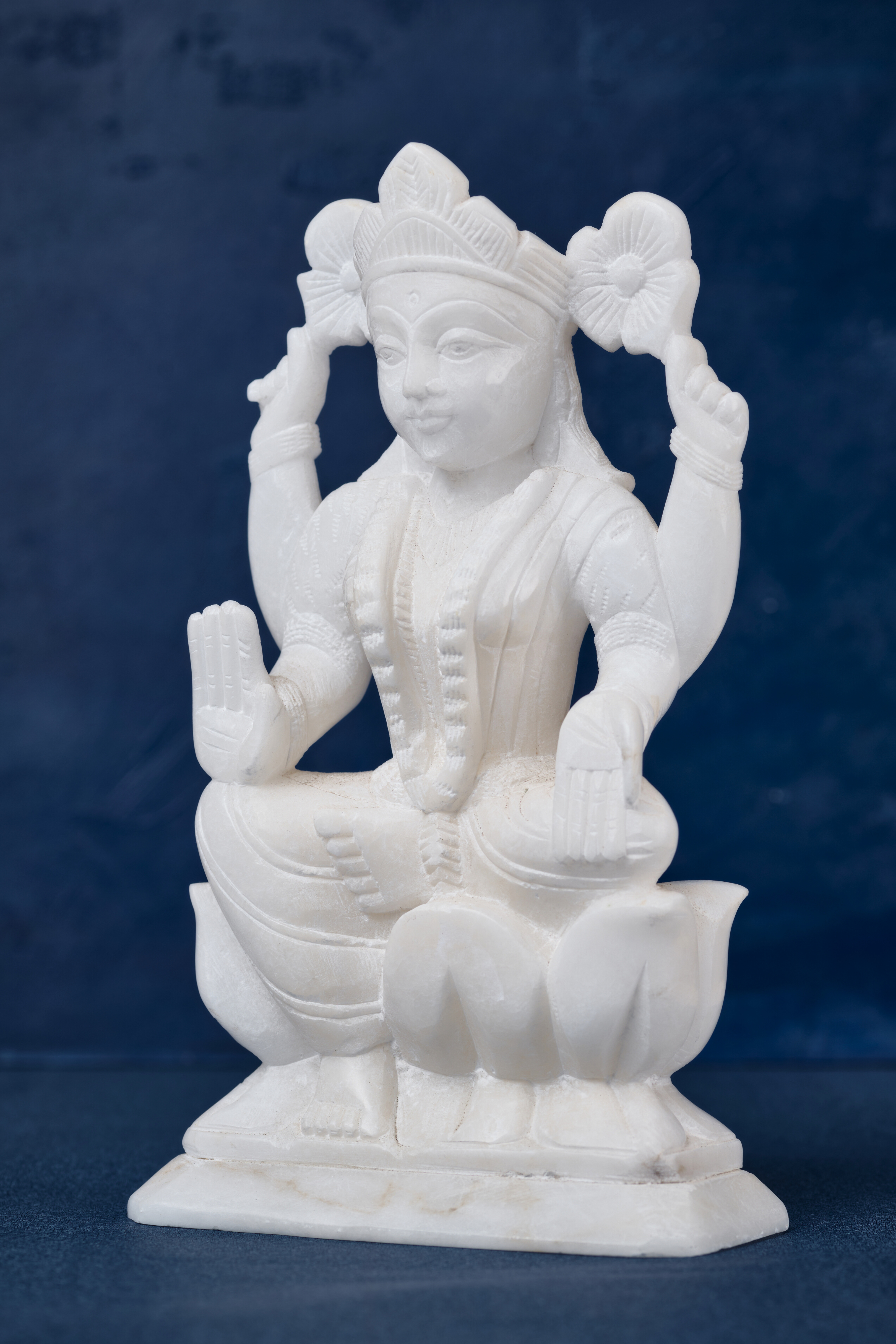 White stone Lakshmi goddess statue depicting prosperity and abundance, crafted as an elegant spiritual accent for home décor