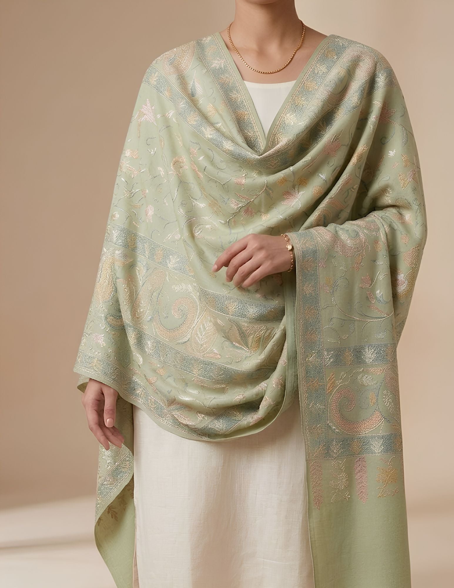 Sage green Sozni stole worn over one shoulder.