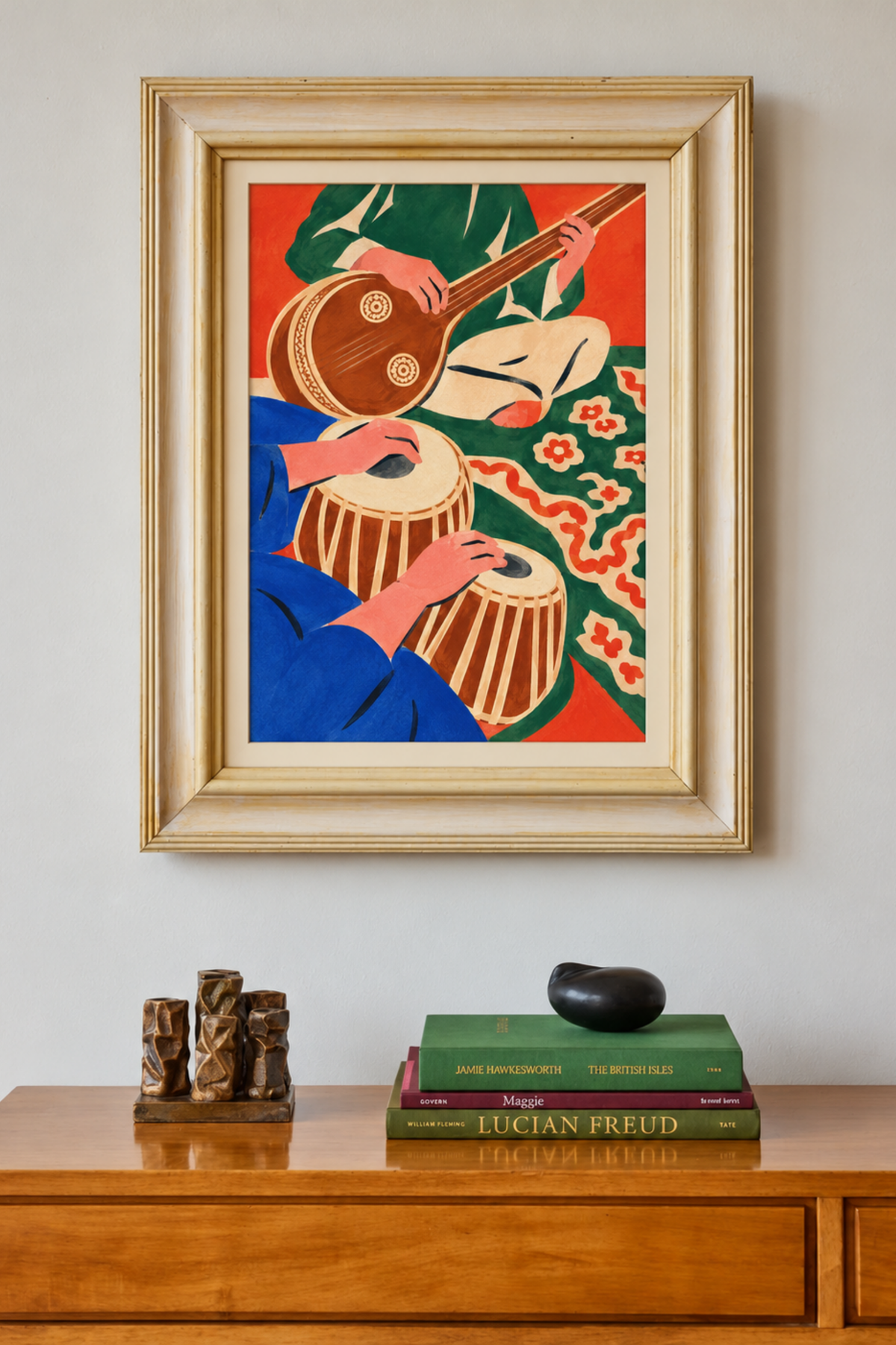 Framed music painting of a stringed instrument and drums on a wall above a wooden sideboard with books