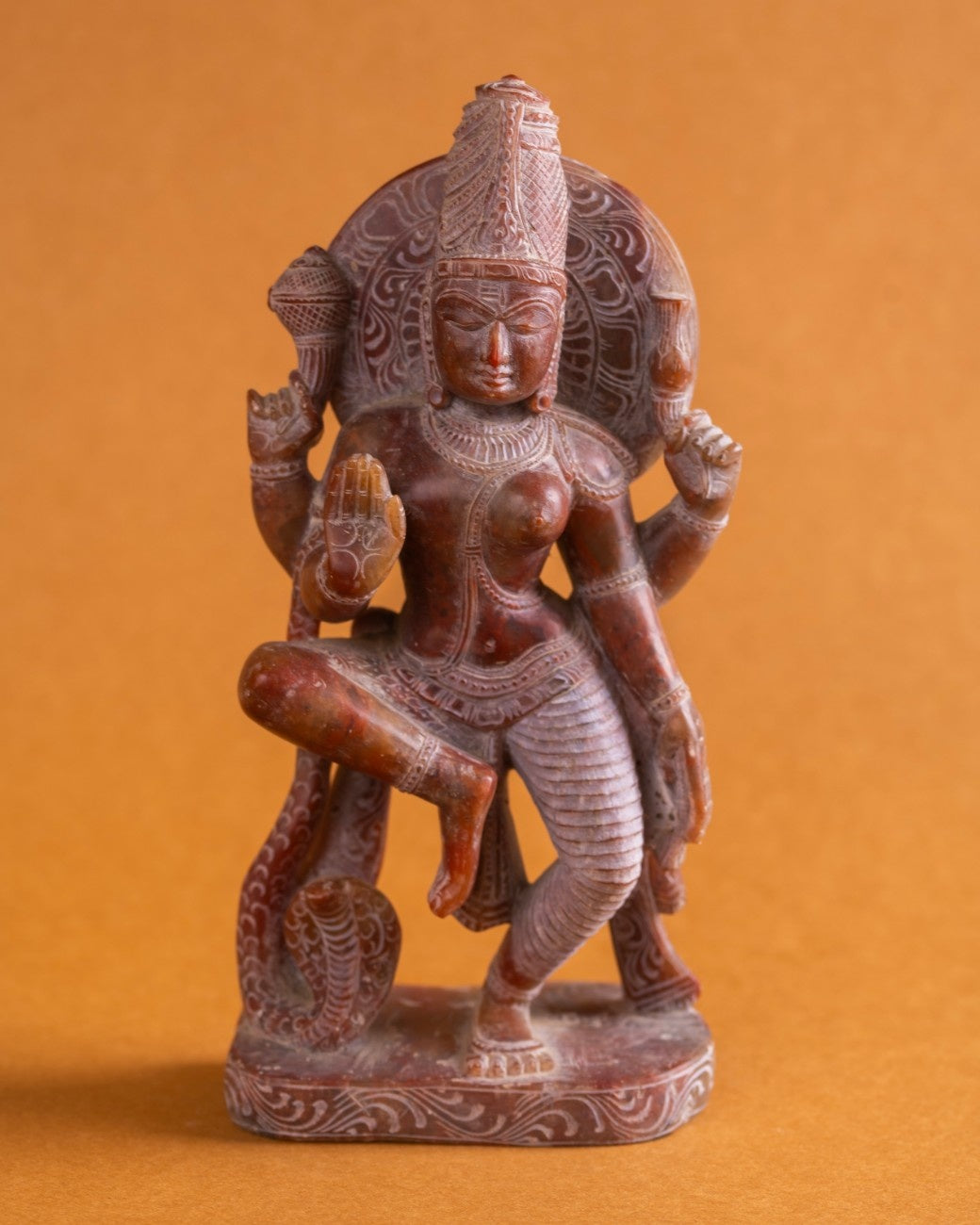 Red stone Ardhanarishwar statue of Shiva and Parvati, handcrafted Indian sculpture.