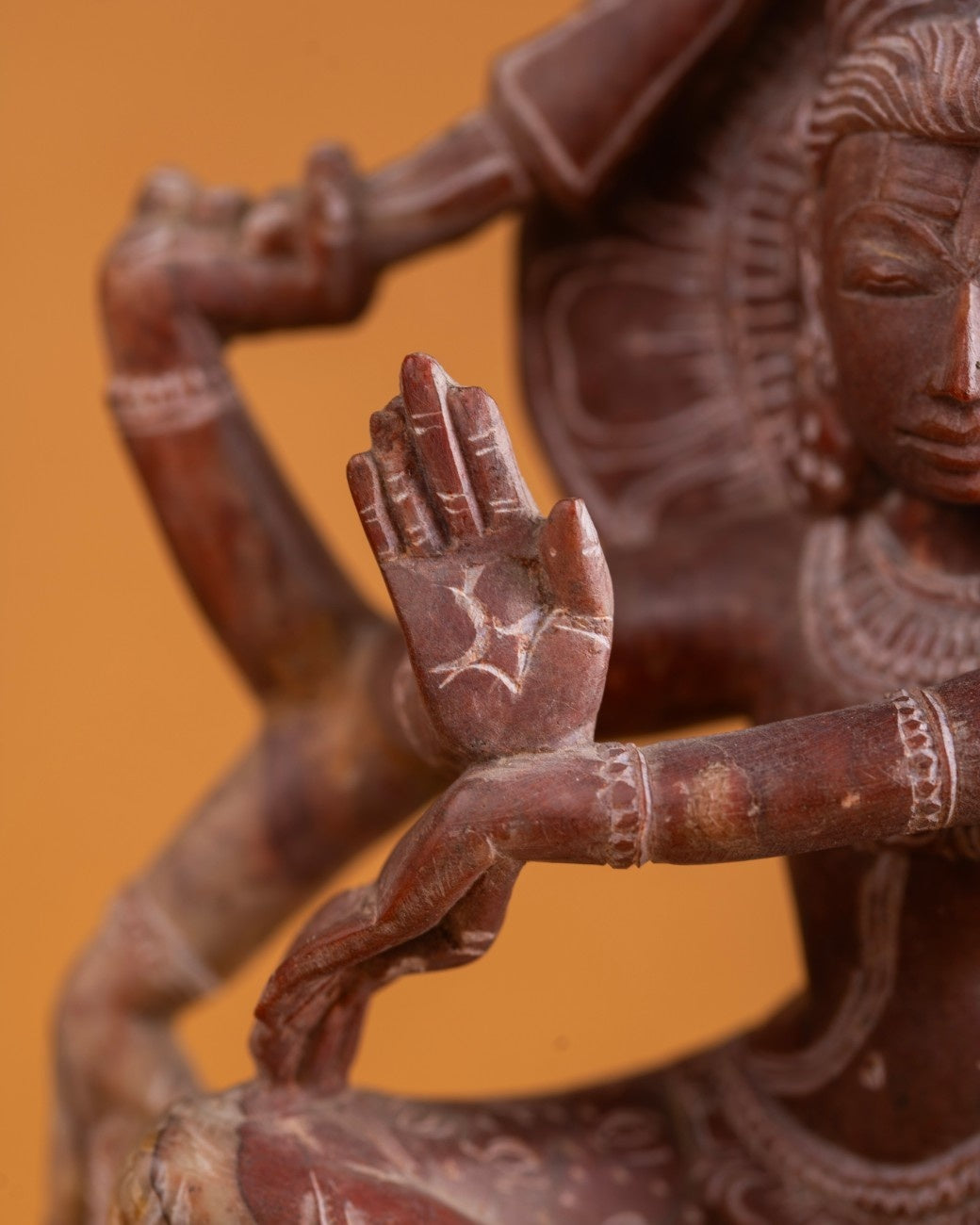 Shiva idol hand detail carved in red stone.