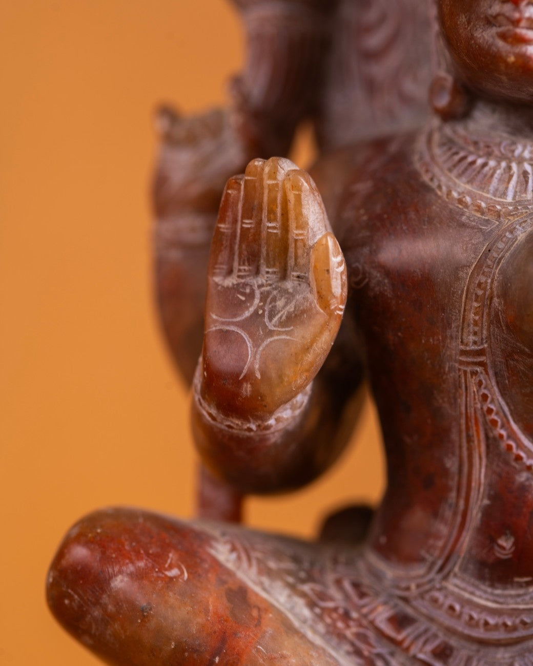 Close-up of Ardhanarishwar sculpture face and upper body with detailed carving.