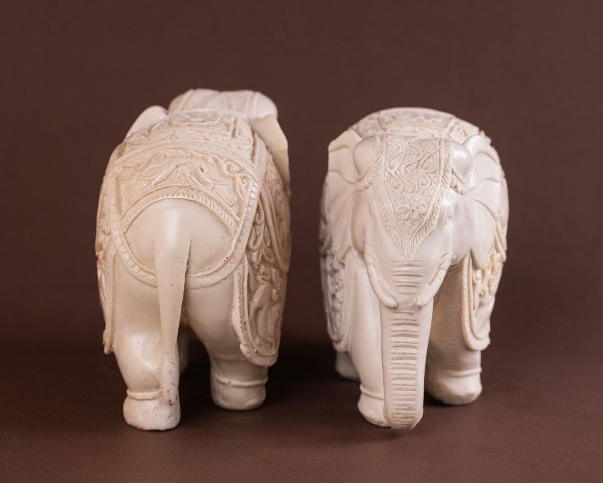 White elephant sculpture pair with detailed Indian carvings perfect for boho, ethnic, and artisan décor themes.