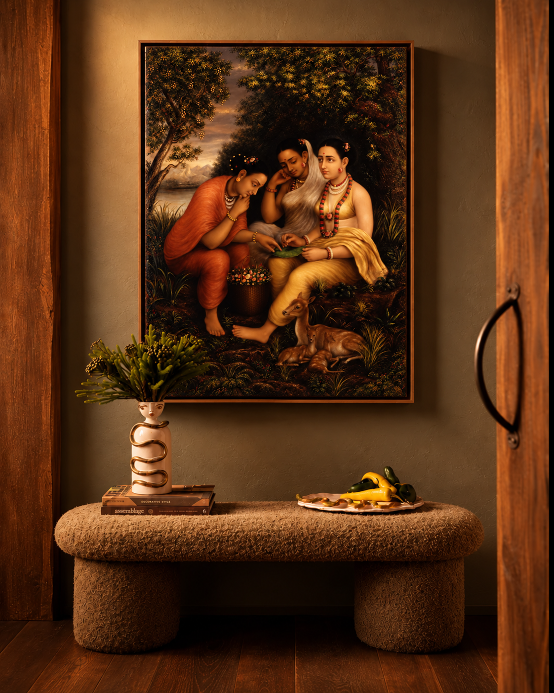 Framed print of the three women on a dark wall above a boucle bench with a vase and a plate of peppers