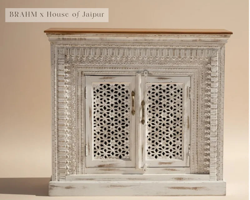 Decorative wooden cabinet with intricate carvings on a beige background, featuring 'BRAHM x House of Jaipur' branding.