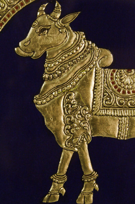 Close-up of Golden Cow Mysore Painting highlighting intricate Gesso relief work, 22KT gold leaf embellishments, and delicate brushwork, exemplifying the classical Mysore painting craftsmanship and ornate detailing.