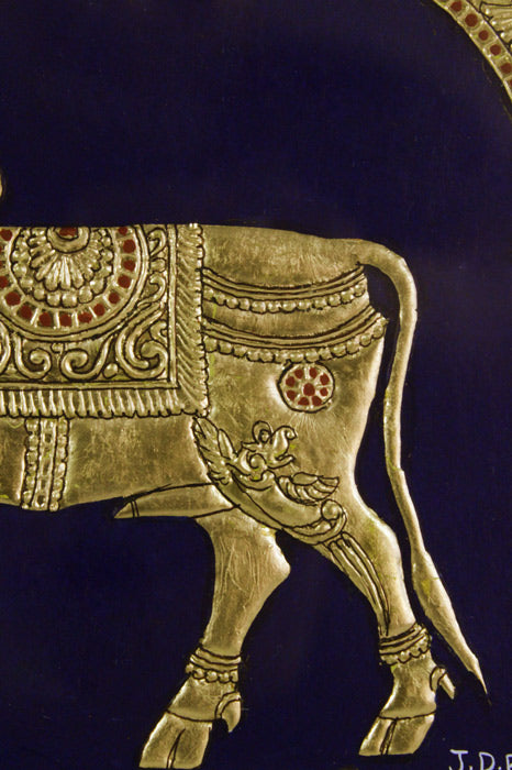 Close-up of Golden Cow Mysore Painting highlighting intricate Gesso relief work, 22KT gold leaf embellishments, and delicate brushwork, exemplifying the classical Mysore painting craftsmanship and ornate detailing.