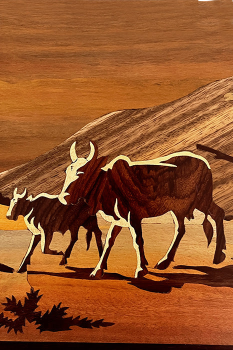 Close-up of Mysore rosewood inlay craftsmanship showing cow grazing motif, natural wood inlay detailing and hand-carved finish