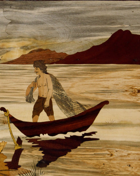 Close-up detail of handcrafted Mysore rosewood inlay showing fishing figures, fine carving, and natural wood contrasts.