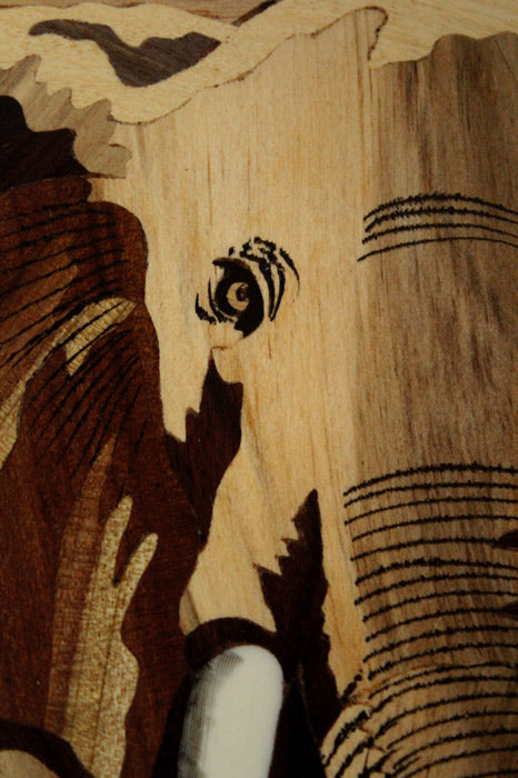 Close-up detail of Mysore rosewood inlay elephant artwork highlighting precision wood inlay, natural grain textures, layered woods, and traditional handcrafted detailing.