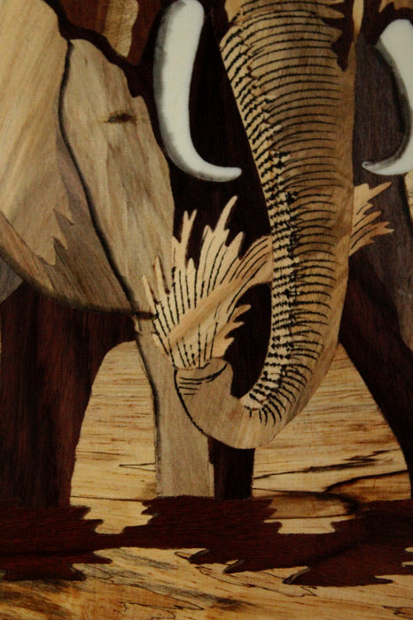 Close-up detail of Mysore rosewood inlay elephant artwork highlighting precision wood inlay, natural grain textures, layered woods, and traditional handcrafted detailing.
